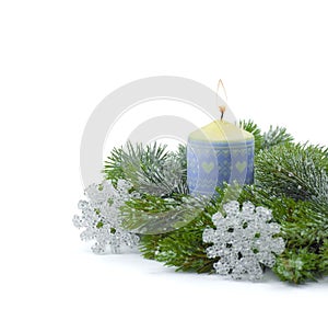 New Year`s decor. Christmas composition: spruce branches with a candle and tinsel. Isolated on white. Copyspace