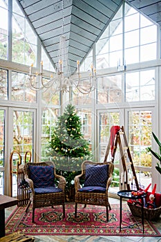 New Year`s decor of a country house with large windows.