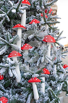 New Year`s decoration, vertical. Artificial eco spruce and decorations in the fly agaric. Beautiful Christmas tree with