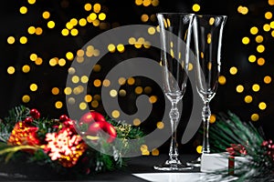 New Year's Eve 2022. Champagne glass with bokeh lights on dark background