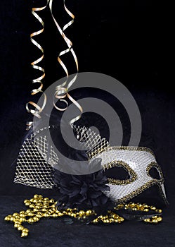 New Year`s Eve carnival mask with curly ribbons