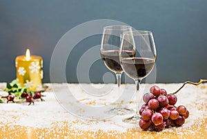 New year's eve cheers with two glasses of red wine and grapes