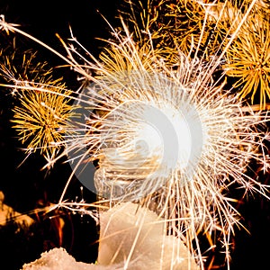 New Year\'s Eve. Glittering burning sparkler against blurred background. Sparklers in a glass jar.