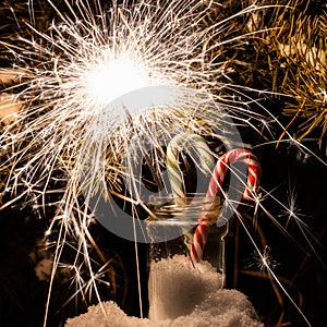 New Year\'s Eve. Glittering burning sparkler against blurred background. Sparklers in a glass jar.