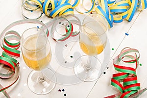 New year's eve party with two filled champagne glasses, colorfu