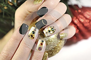 New year`s fashionable beautiful festive manicure on short square nails with green lacquer color.
