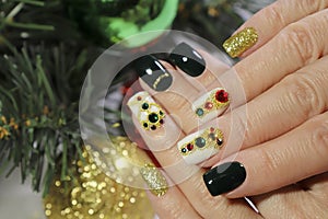 New year`s fashionable beautiful festive manicure on short square nails with green lacquer color. photo