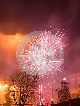 New Year`s fireworks create smoke over houses on the outskirts of the city - Long exposure at night on New Year