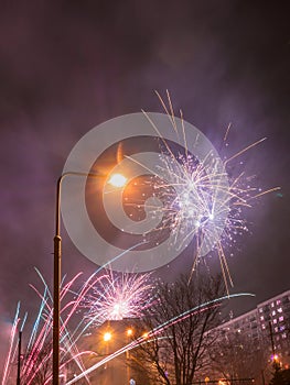 New Year`s fireworks create smoke over houses on the outskirts of the city - Long exposure at night on New Year