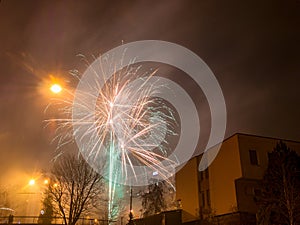 New Year`s fireworks create smoke over houses on the outskirts of the city - Long exposure at night on New Year