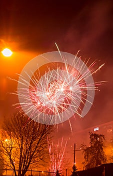 New Year`s fireworks create smoke over houses on the outskirts of the city - Long exposure at night on New Year