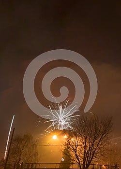 New Year`s fireworks create smoke over houses on the outskirts of the city - Long exposure at night on New Year