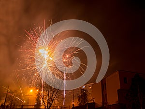 New Year`s fireworks create smoke over houses on the outskirts of the city - Long exposure at night on New Year