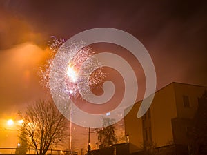 New Year`s fireworks create smoke over houses on the outskirts of the city - Long exposure at night on New Year
