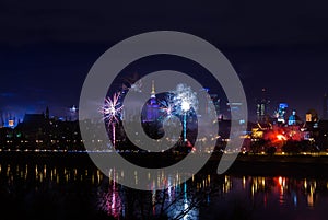 New Year`s fireworks show in Warsaw, Poland at night, view from the Vistula River