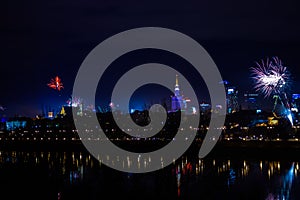 New Year`s fireworks show in Warsaw, Poland at night, view from the Vistula River