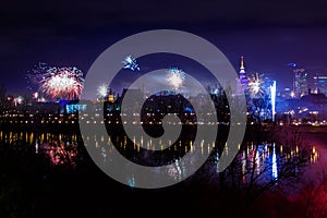 New Year`s fireworks show in Warsaw, Poland at night, view from the Vistula River