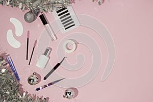 New year`s flatley. Tools for eyelash extension on a pink background, top view. Patches, artificial eyelashes, brushes, glue,