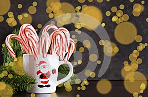 New Year`s food background. Candy canes in a cup