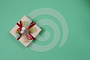 New Year`s gift in craft paper on a plain green background