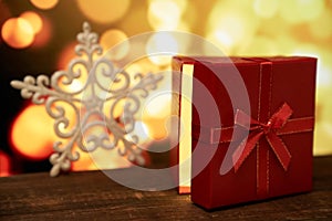 New year`s gift on a wooden table with a bokeh background