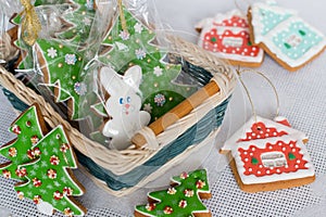 New Year`s gingerbread decorated with icing in a basket. Christmas homemade gingerbread cookie in a wicker basket