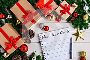 New Year`s Goals List written on Notebook with Christmas fir tree and decoration