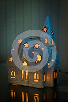 New Year`s house with a candle mysteriously look