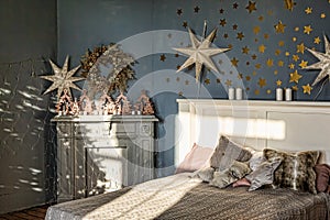 New Year`s interior. Bedroom with fireplace decorated with Christmas stars. Sweet home