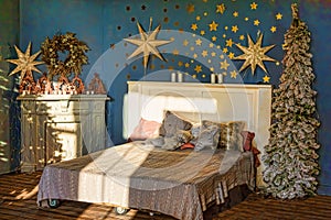 New Year`s interior. Bedroom with fireplace decorated with Christmas stars. Sweet home