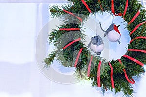 New year`s interior. Christmas wreath. Toy birds bullfinches