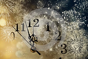 new Year& x27;s at midnight - clock at twelve o& x27;clock with holiday lights and fireworks