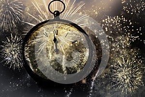 new Year& x27;s at midnight - clock at twelve o& x27;clock with holiday lights and fireworks