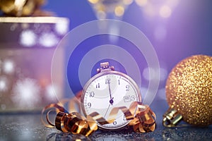 New Year\'s at midnight - Old clock with Christmas decoration, champagne and holiday lights