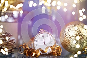 New Year\'s at midnight - Old clock with Christmas decoration, champagne and holiday lights