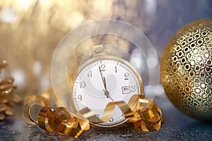 New Year\'s at midnight - Old clock with Christmas decoration, champagne and holiday lights