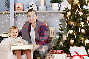 New Year`s photo of father and son against background of spruce