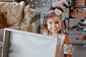 New Year`s portrait of a girl on the background of a Christmas tree, Christmas mood, winter holiday, children`s laughter