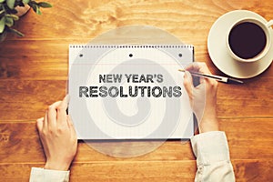 New Year`s Resolutions with a person holding a pen