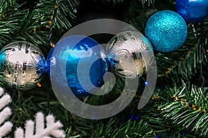 New Year`s round balls on the tree. Green spruce branches are decorated with toys. Christmas background. New year concept