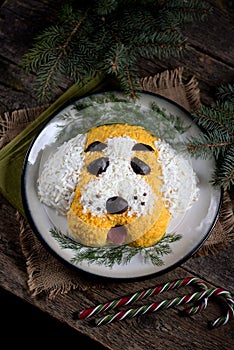 New Year`s Salad `Dog` for the celebration of 2018 - the year of the Yellow Dog. Salad of smoked chicken, boiled potatoes, soft ch