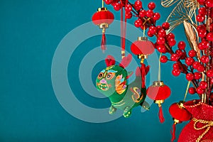 A New Year's toy in the shape of a green dragon hangs on a branch tree. Festive background. Chinese horoscope