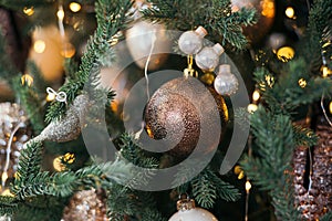 New Year`s toys. Decorated Christmas tree on a blurry, sparkling and fabulous background. Garland and bokeh. Bright Lights