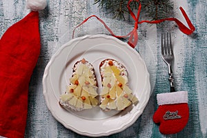 New-year sandwiches with cheese, pineapples and crab stiks in the form of a Christmas tree photo