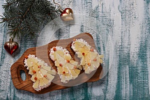 New-year sandwiches with cheese, pineapples and crab stiks in the form of a Christmas tree photo