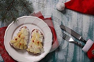 New-year sandwiches with cheese, pineapples and crab stiks in the form of a Christmas tree photo