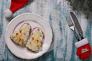 New-year sandwiches with cheese, pineapples and crab stiks in the form of a Christmas tree photo