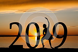 2019 New Year Silhouette of Ballet Girl at Golden Sunset