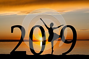 2019 New Year Silhouette of Ballet Girl at Golden Sunset