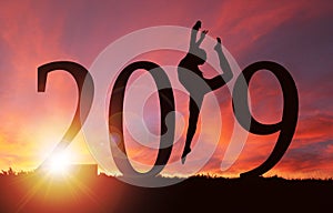 2019 New Year Silhouette of Girl Dancing at Golden Sunrise